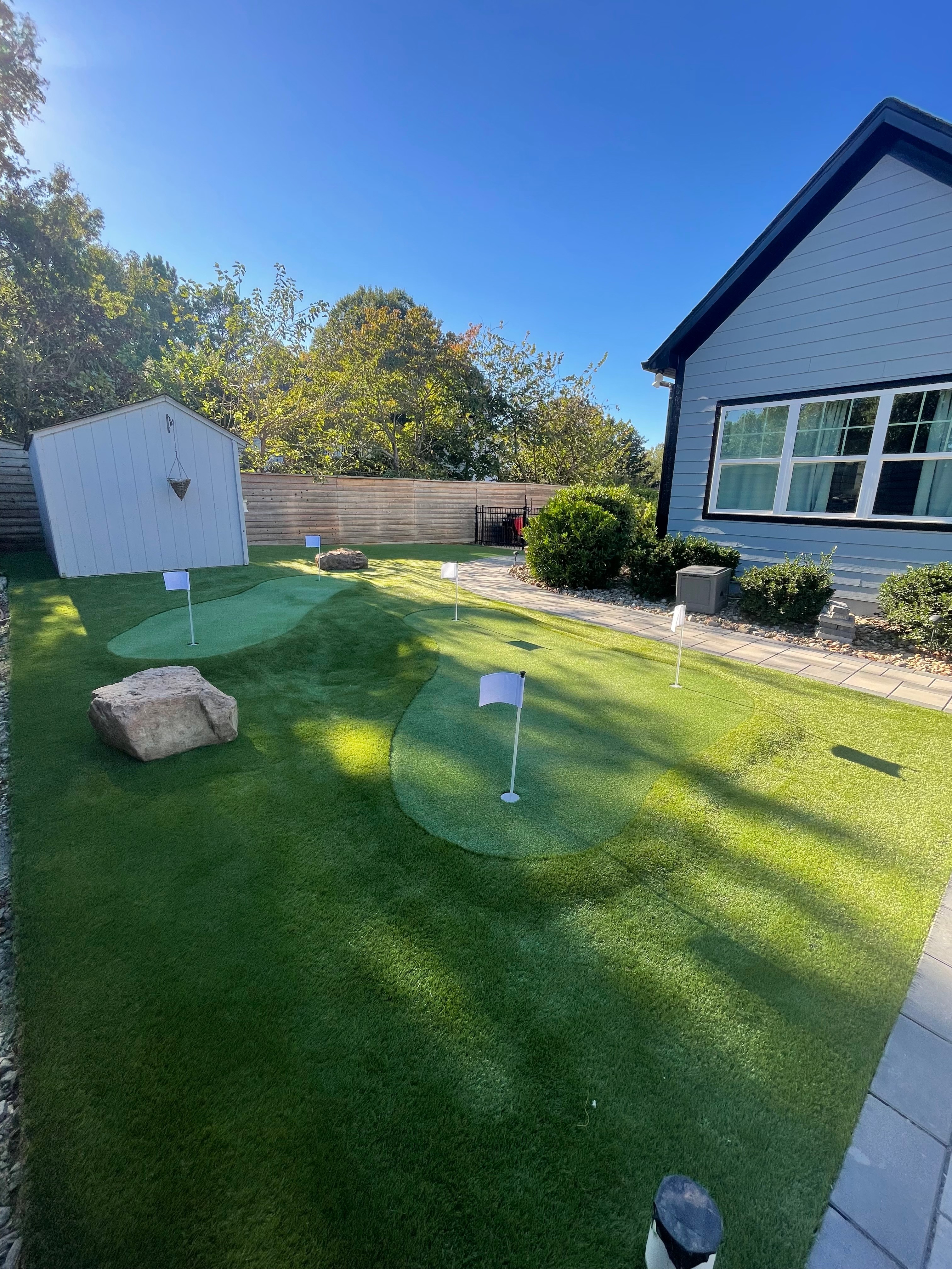 Beautiful artificial turf installation with putting green